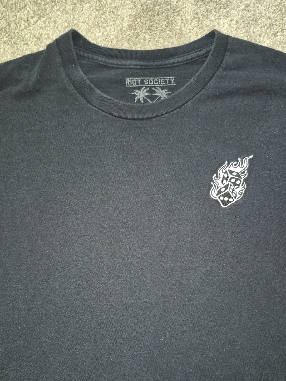 riot society black tee with white flaming dice chest graphic